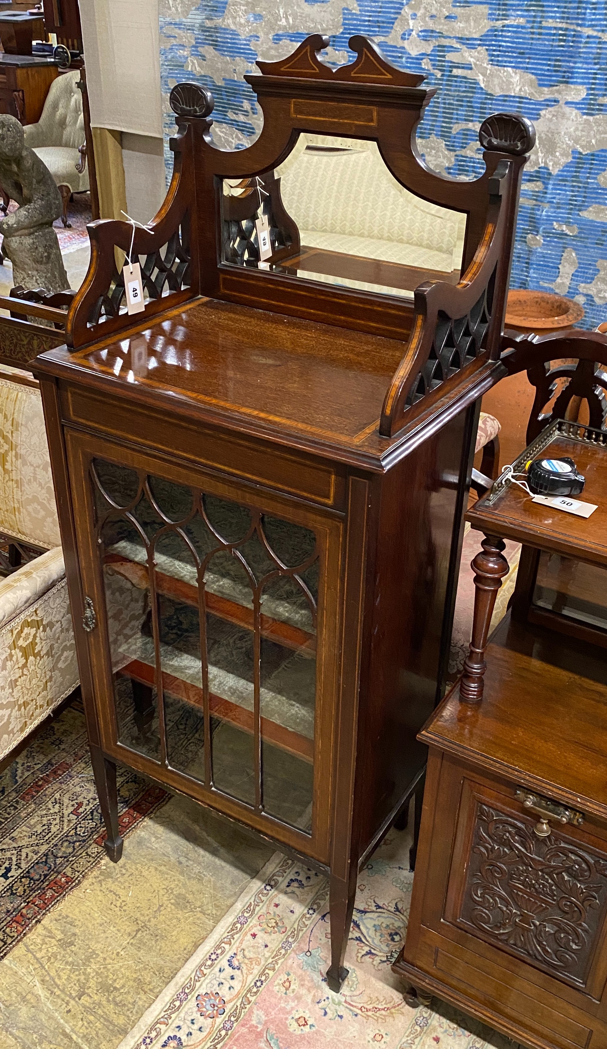 An Edwardian satinwood banded mahogany mirrored back music cabinet, width 56cm, depth 36cm, height 140cm